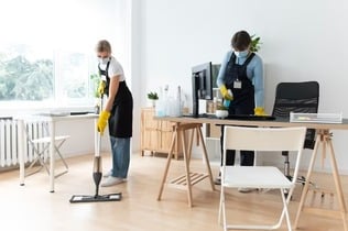 2 girls providing  housekeeping Services: cleaning chair, table and Floor